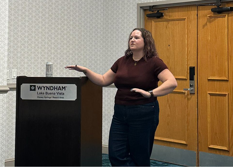 marisa speaking at podium at brainstorm conference
