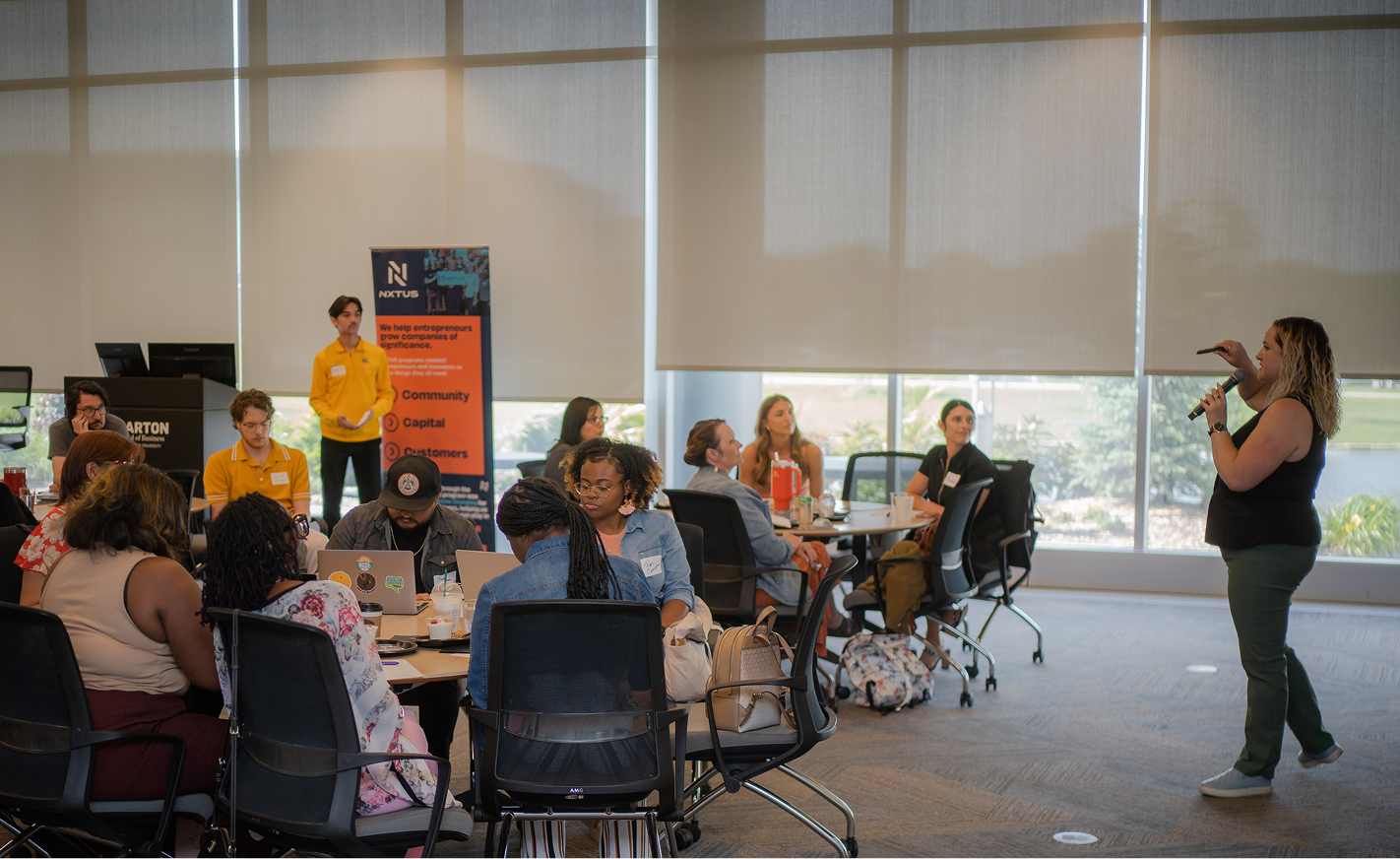 marisa talking to attendees at NXTUS event