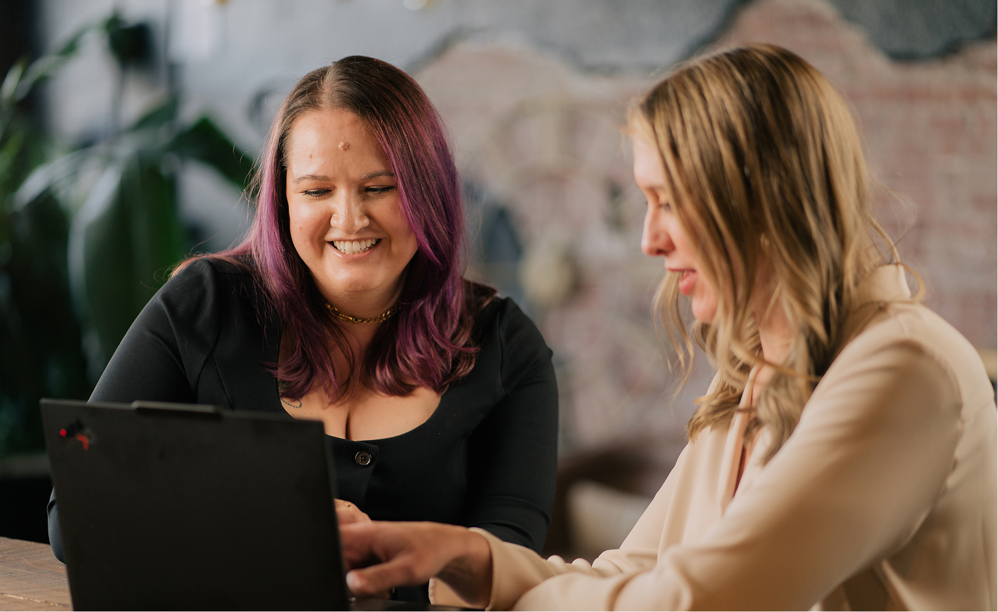 Marisa working on laptop with a client
